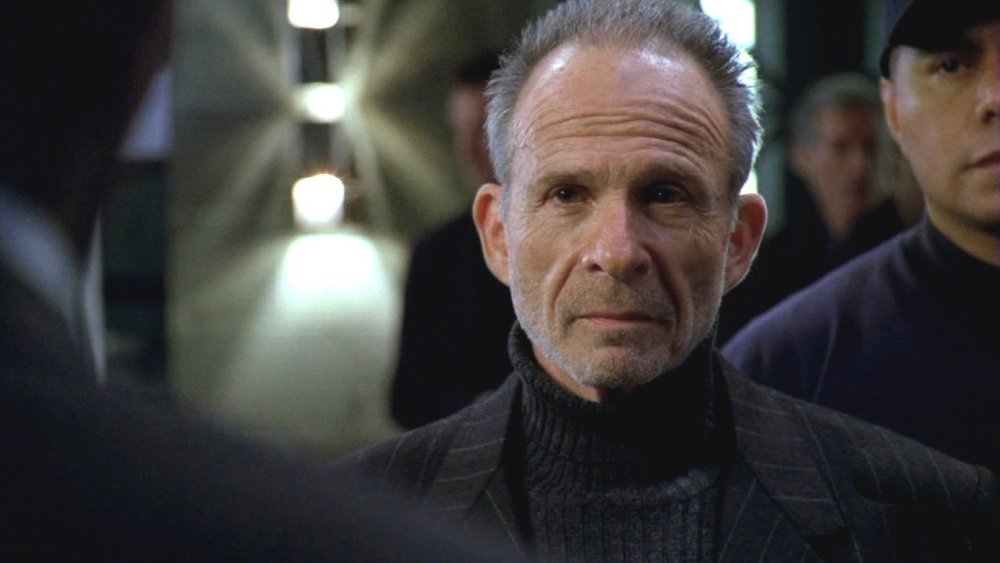 Ron Rifkin as Arvin Sloane in Alias, watching someone with a flat, unreadable expression