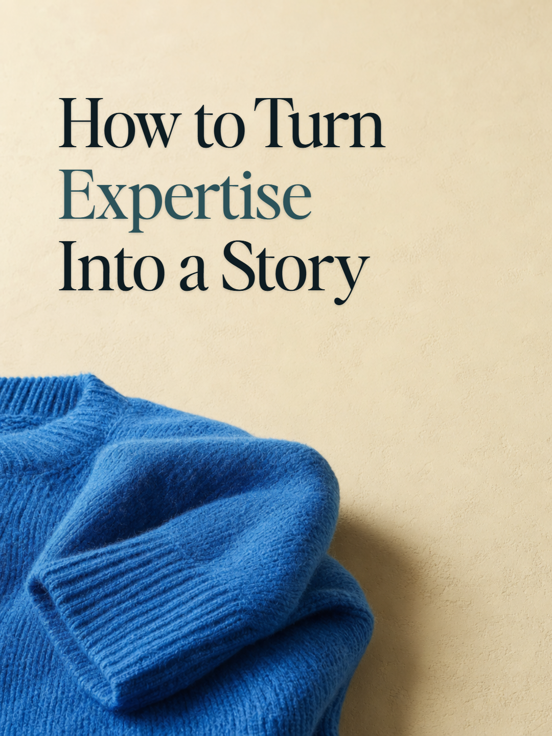 A folded cerulean-blue sweater low on a warm parchment surface — cover for How to Turn Expertise Into a Story.