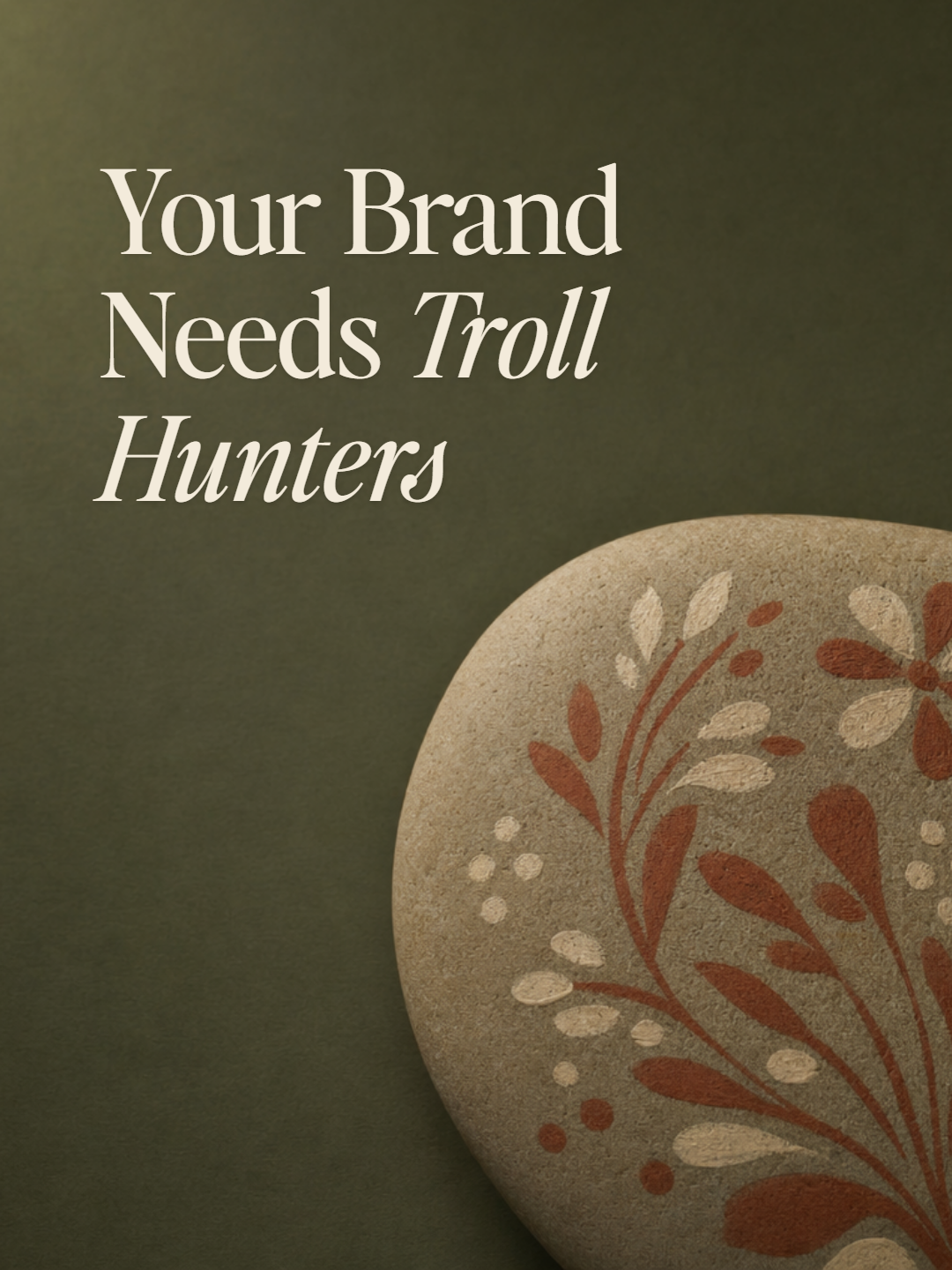 A smooth river stone hand-painted with a folk floral motif on deep olive — cover for Your Brand Needs Troll Hunters.