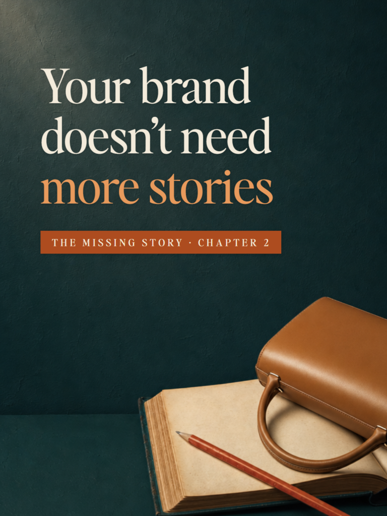 An open blank book on a deep teal table with a red pencil across one page and a plain tan leather handbag lying on its side on the other. The Missing Story, Chapter 2: Your brand doesn't need more stories
